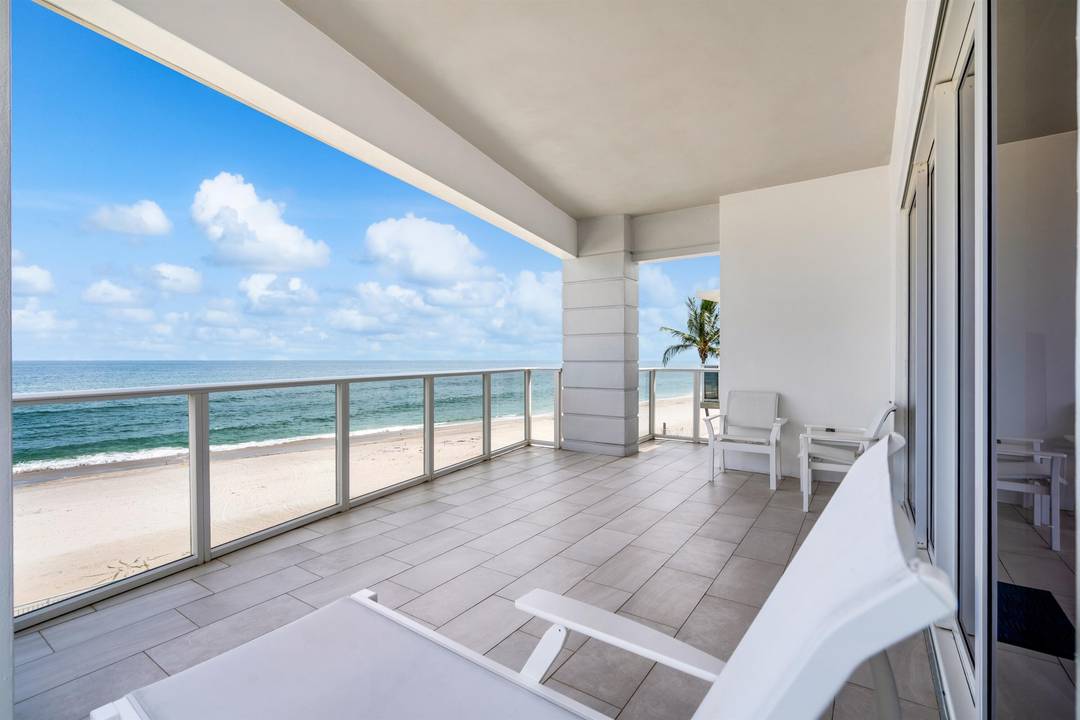 Rare oceanfront corner penthouse with sweeping views up and down the coastline, perfectly positioned along a serene stretch of beachfront.