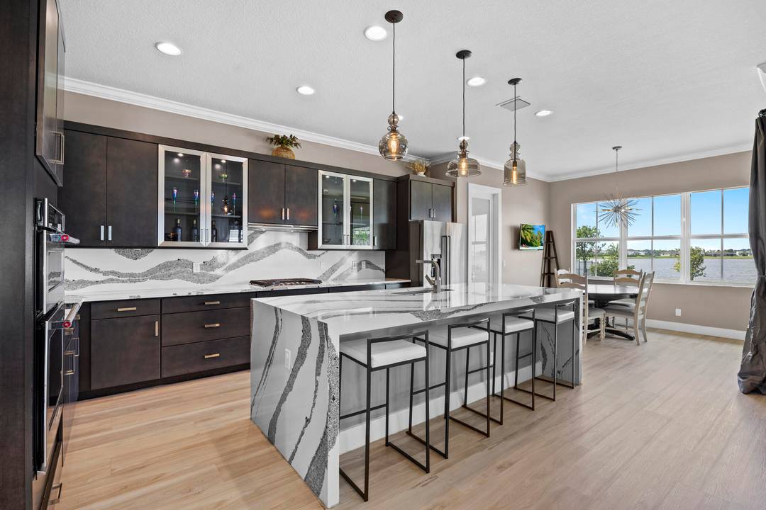 Built by Kenco in 2021, this nearly 4, 000 SF lakefront home has soaring ceilings, an open flow designer level upgrades at every turn that are anything but builder basic.