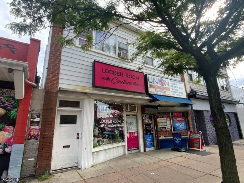 3 apartments, 2 stores 400 sq ft garage front rear unfinished basement.