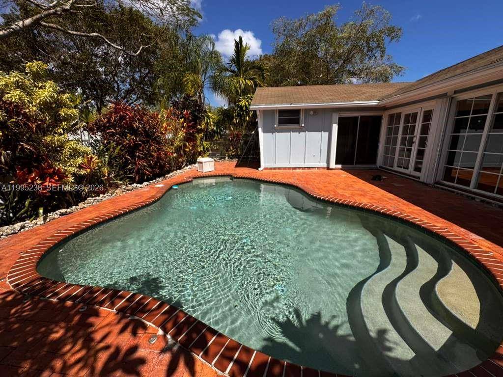 Corner home in desirable Country Walk featuring 3 bedrooms and 2 bathrooms, offering privacy and extra outdoor space.