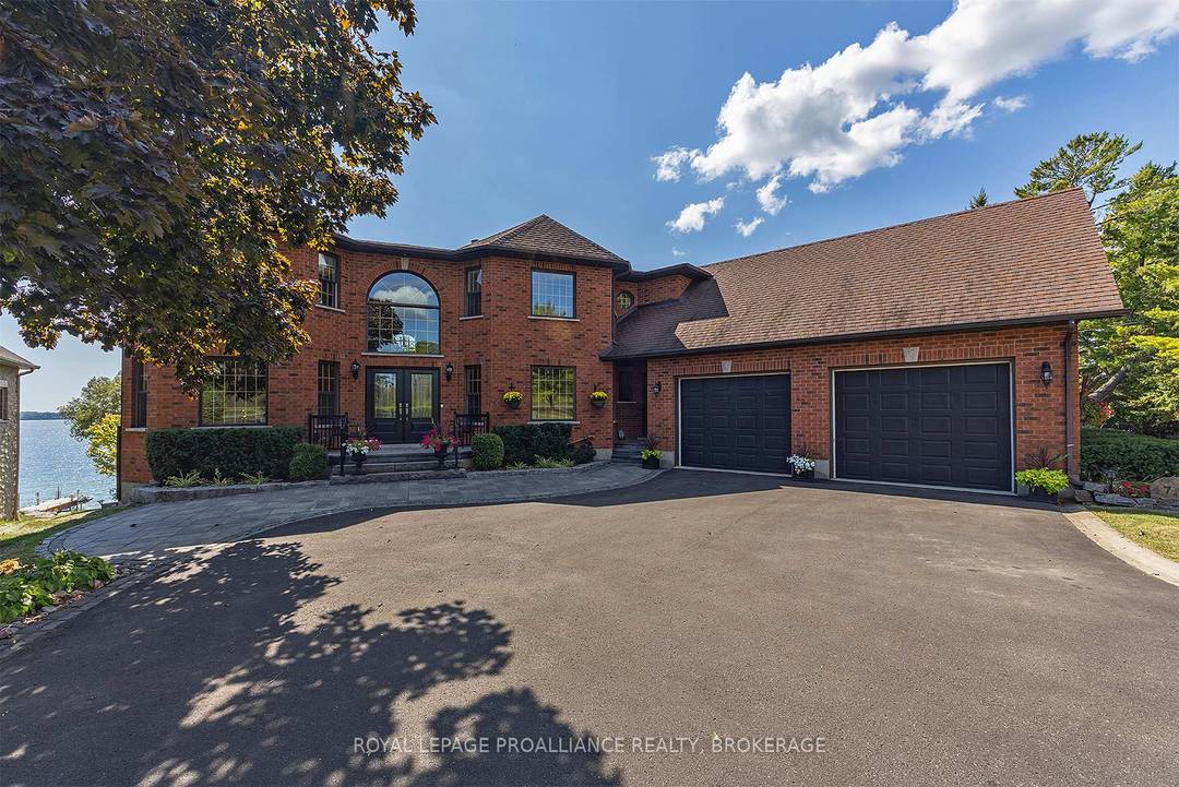 Stunning waterfront views and exceptional craftsmanship define this meticulously designed executive family home, ideally situated along a sheltered cove on Lake Ontario with desirable southern exposure.