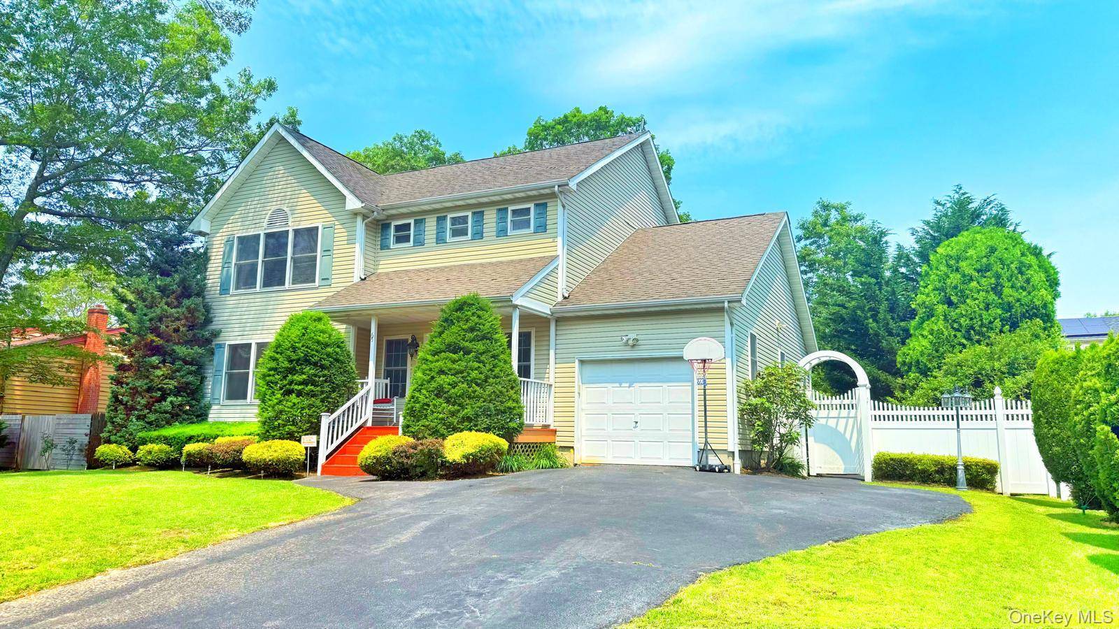 Charming 3BR Home with Garden Oasis Near the LIE This beautiful single family home features a welcoming front porch, lush manicured gardens, and mature trees.
