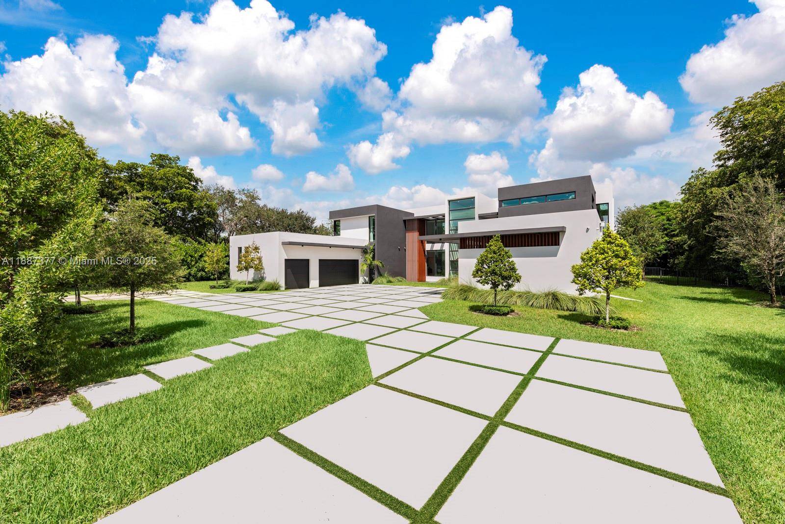 Stunning and luxurious 2024 two story estate on a prime deep and lush gated Pinecrest acre.