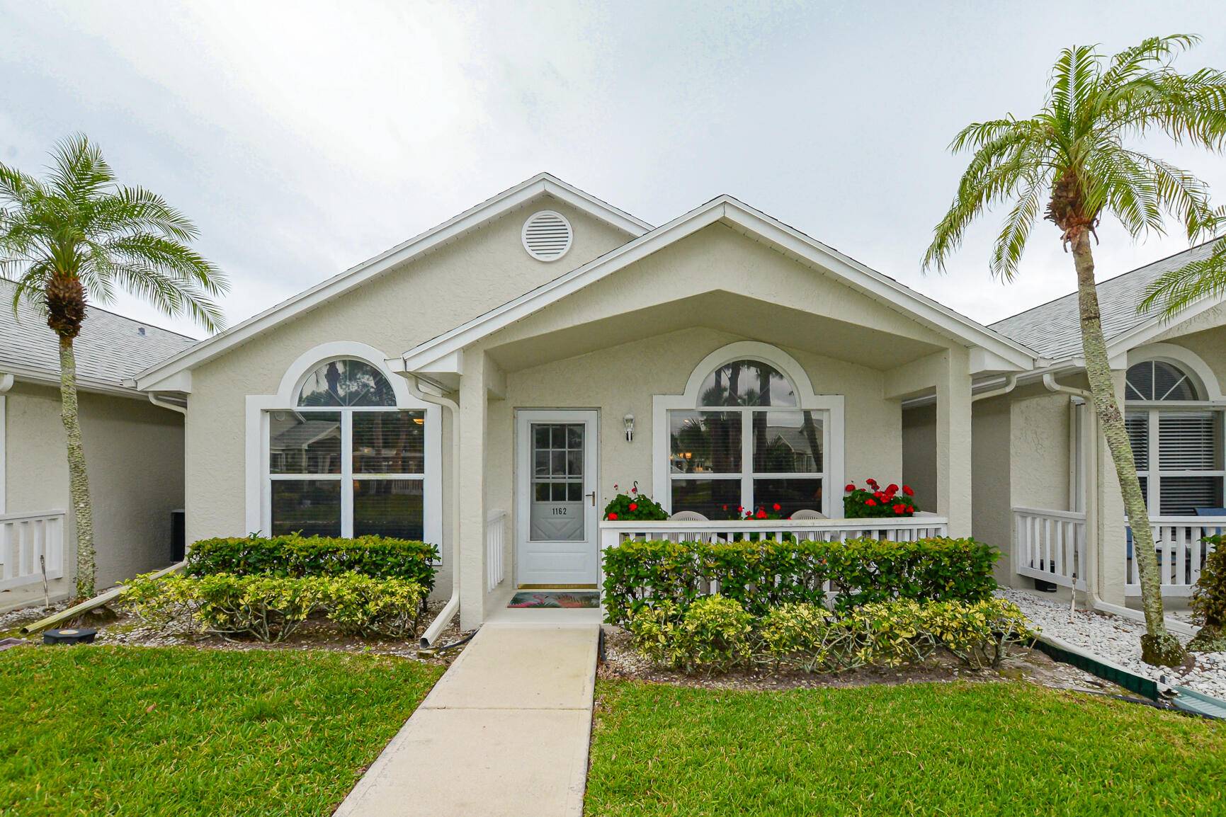 Fabulous Villa with Updated Roof 2022 Carport in Isle of Lombardy in Kings Isle 55 community.