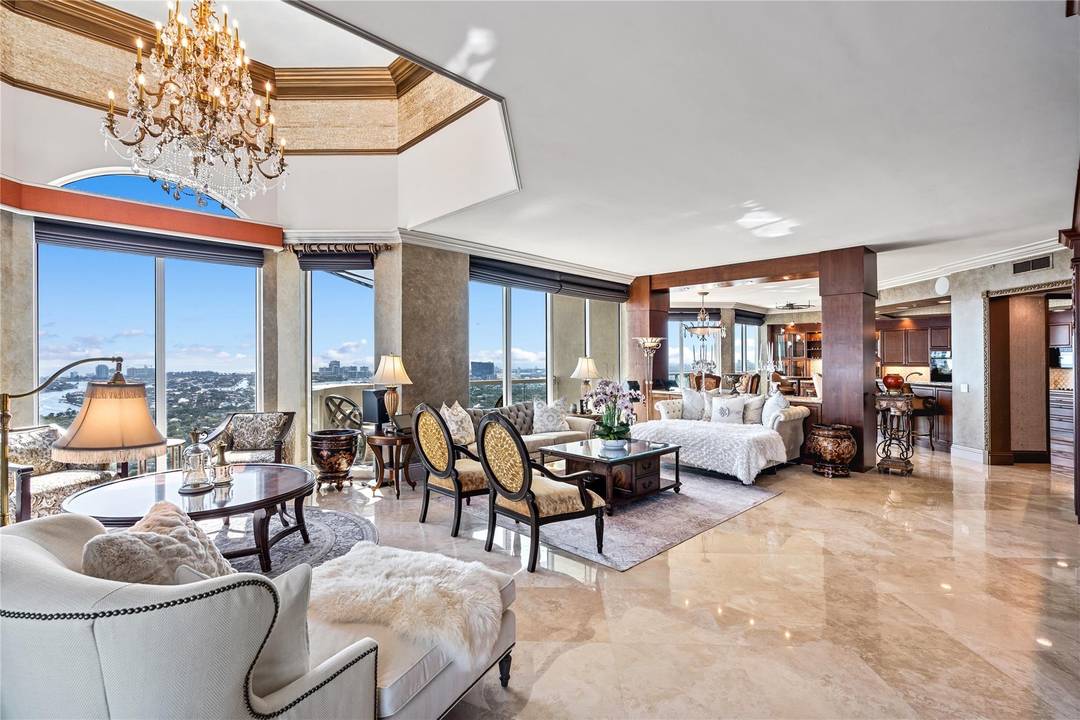 Elegantly Re Imagined Corner Penthouse, offered fully furnished, boasts 4, 200 total sqft of European refinement with sweeping views of the Ocean, New River, and Cityscape.