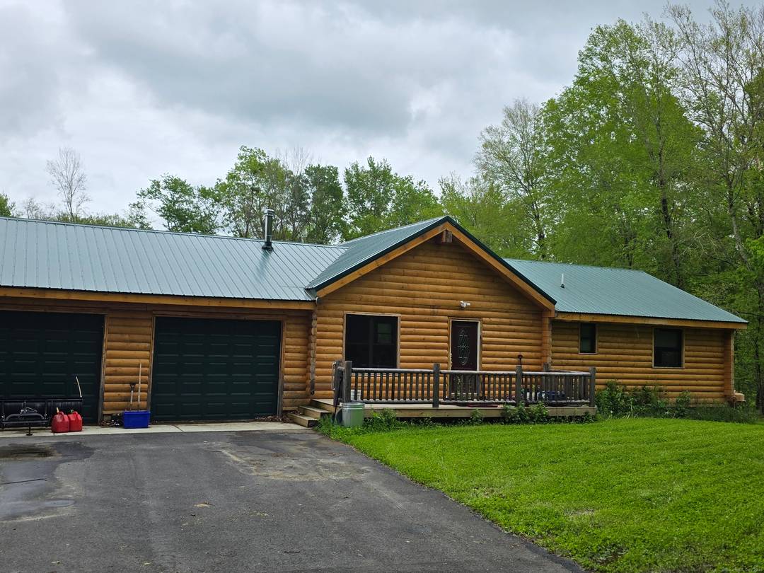 Beautiful 2 year old log home on almost 20 ACRES in pleasant rural, private location.