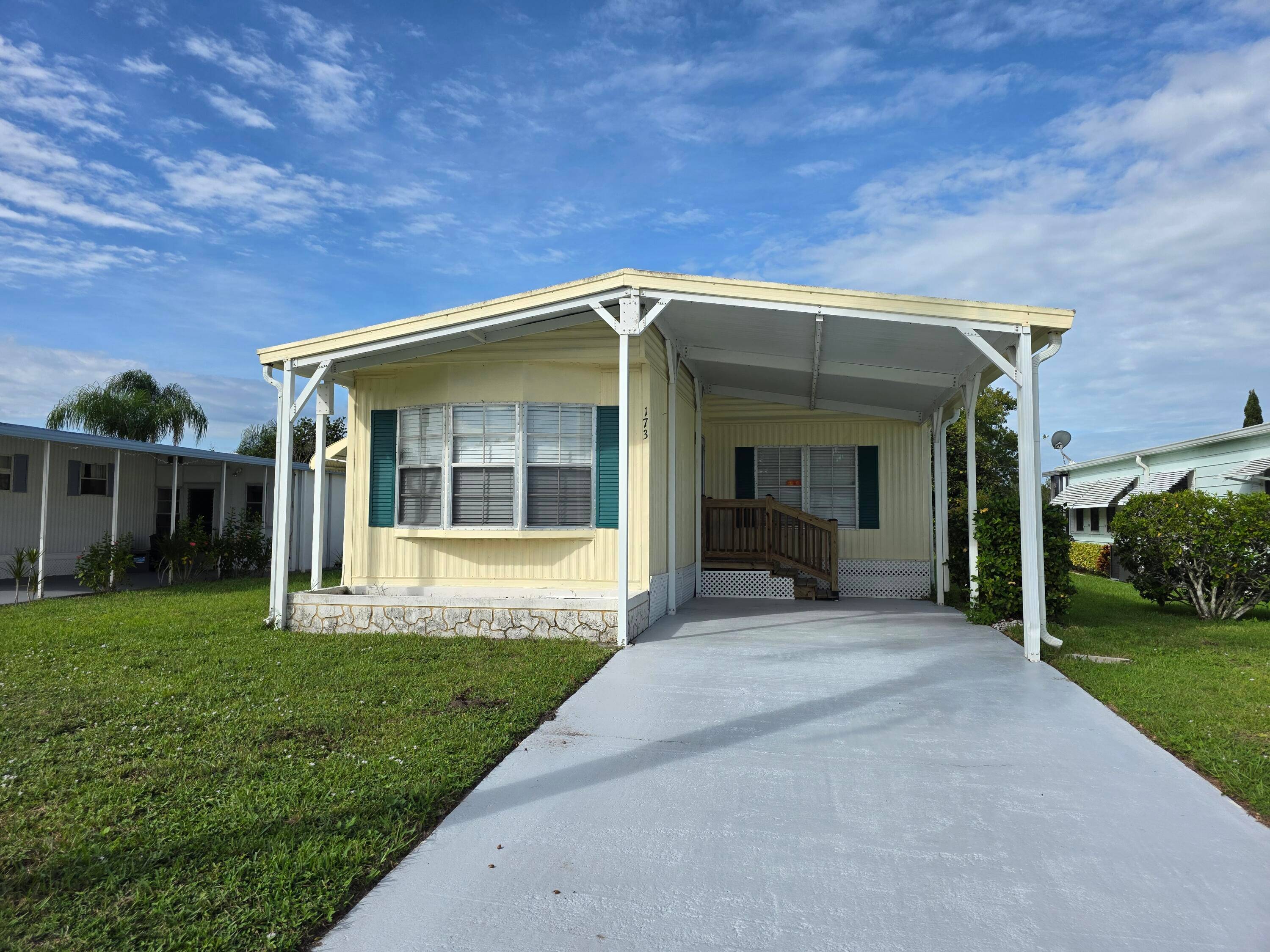 Discover this lakefront gem in Spanish Lakes Riverfront, a vibrant 55 land lease community where the monthly lot rent is just 867.