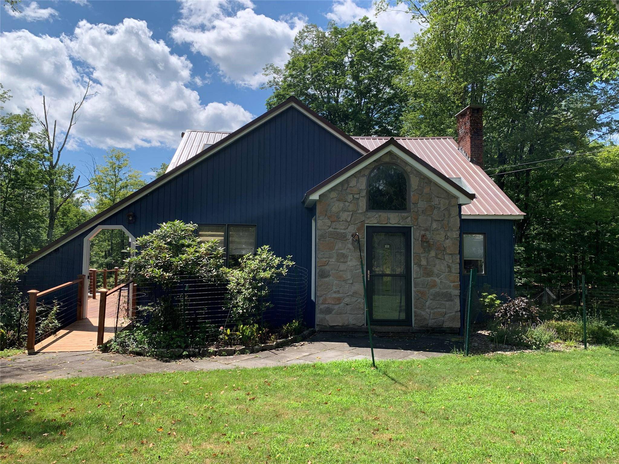 Lawn, rock gardens, flowering, deciduous and evergreen trees on lot.