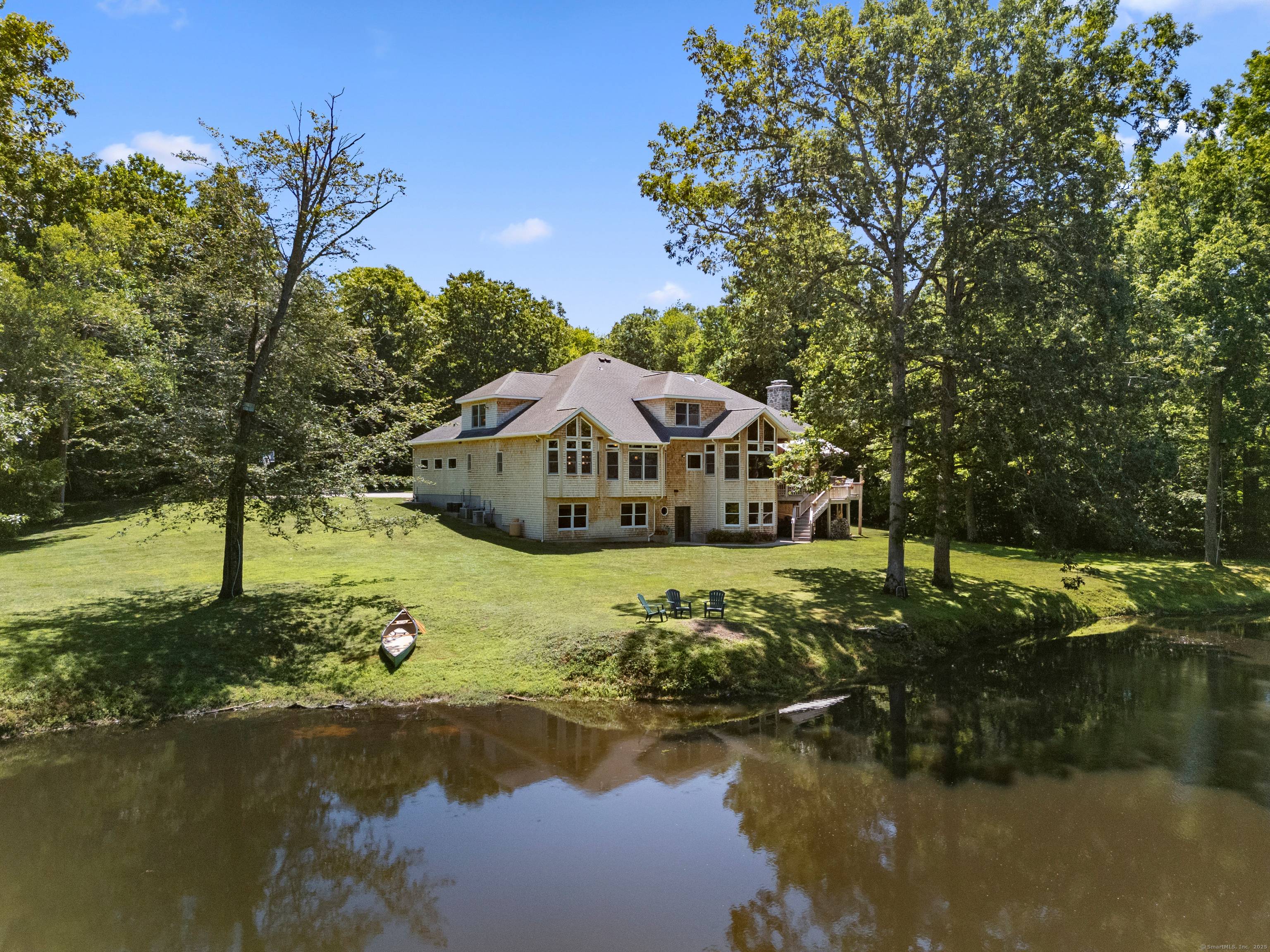 Welcome to Dolce Vita, a stone shingle craftsman prominently sited overlooking the Eight Mile River.
