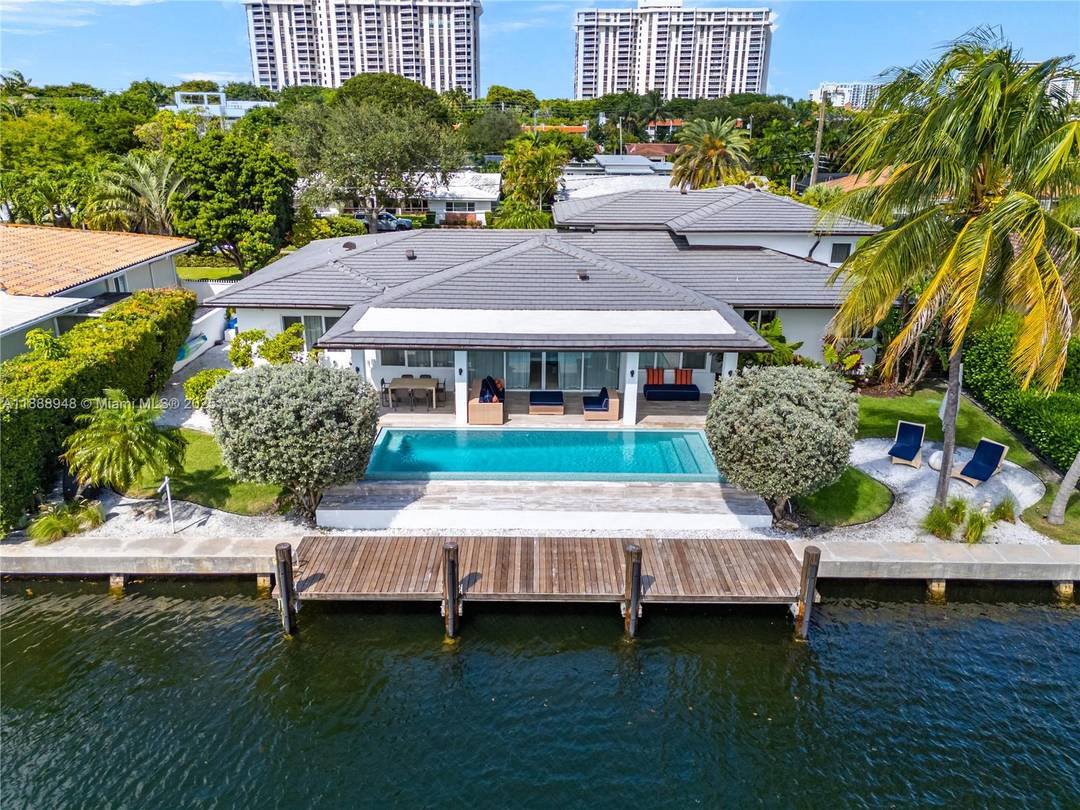 Miami Shores luxury waterfront home with 100 ft of protected waters, 38 ft Ipe dock, and new seawall moments from the open bay, ideal for boaters !