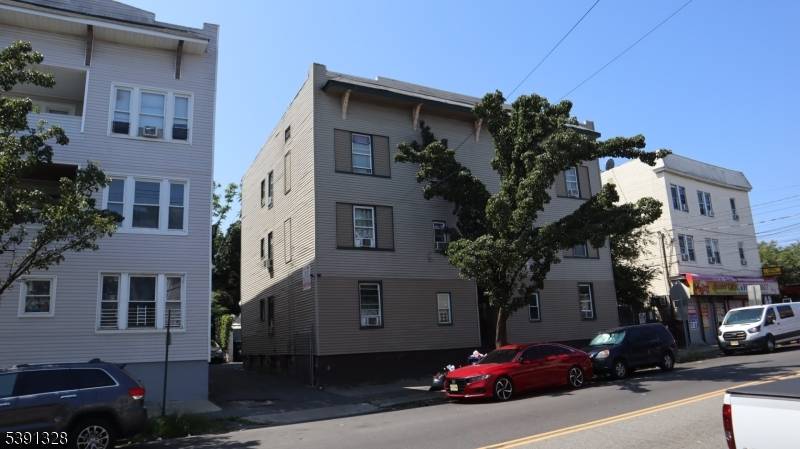 Oversized 6 family apartment building with a large parking area in the rear.