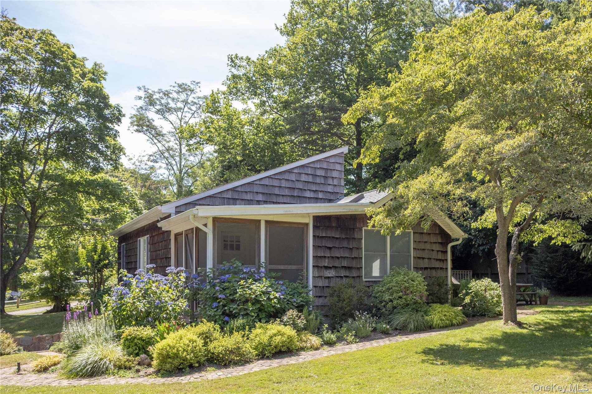 This bright and airy 3 bedroom, 2 bathroom home on Southold's charming Hyatt Road offers a perfect blend of open and closed living spaces.