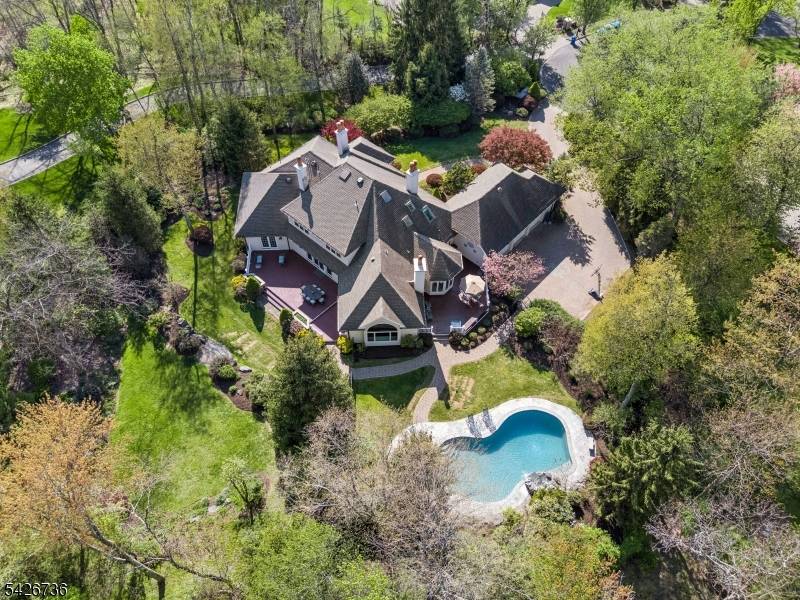 Custom architecture meets an unforgettable setting in this stunning ranch style retreat with a first floor primary suite.
