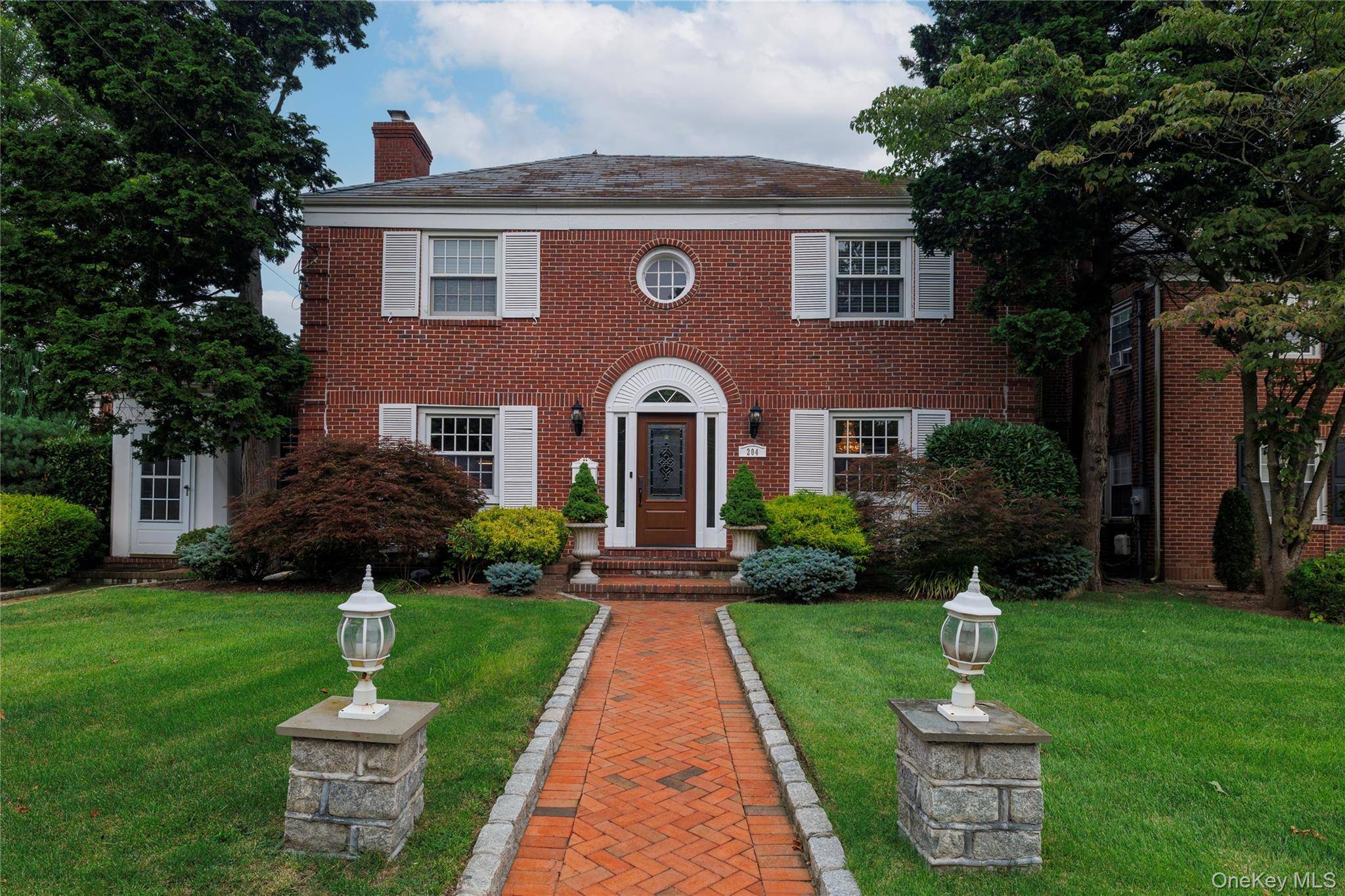 Welcome to this solid brick colonial that is situated on Malverne's prestigious professional row of homes.
