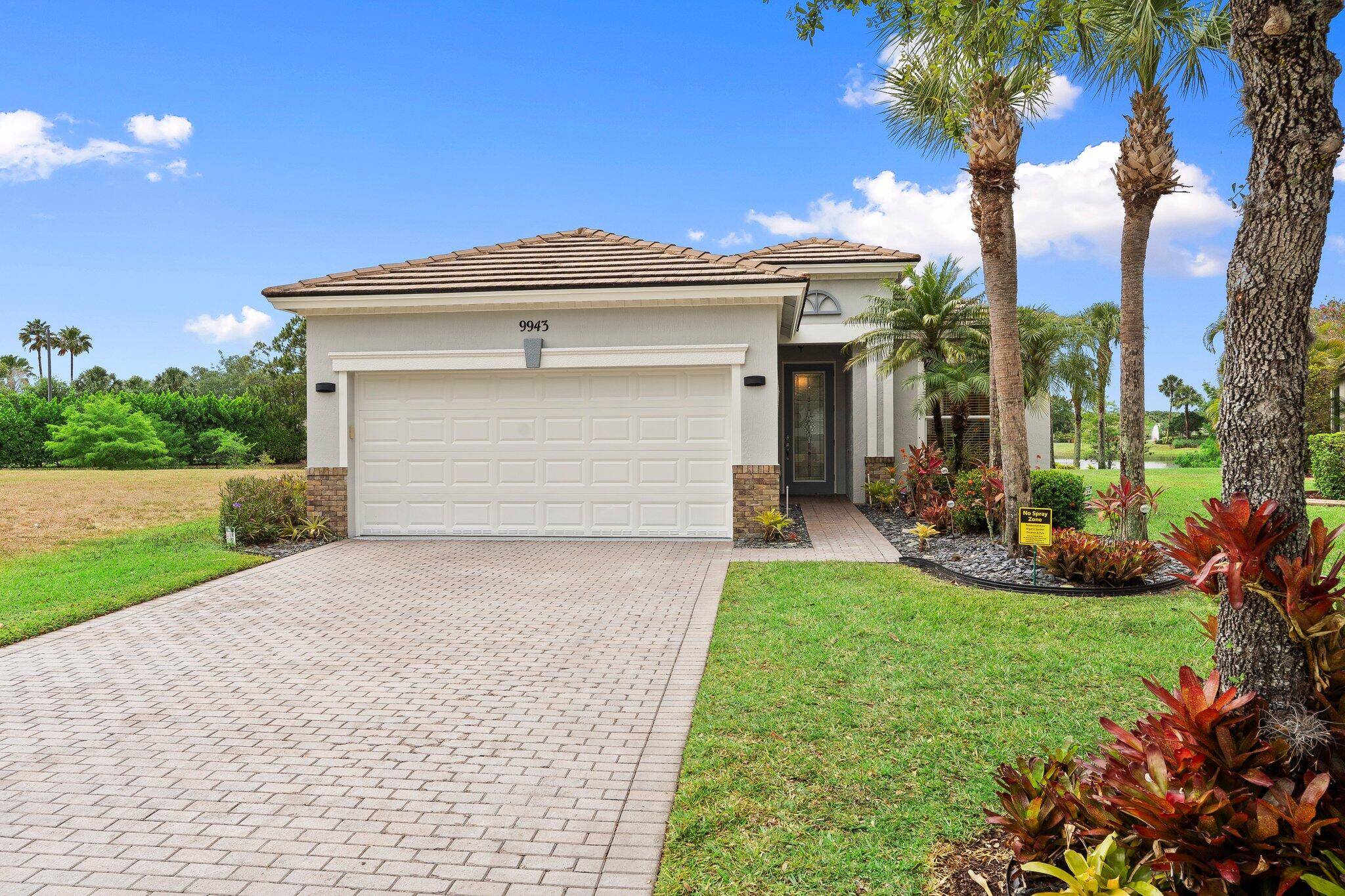 Move in ready Victorian model in the gated Heritage Oaks community of Tradition, offering serene lake views and ultimate privacy.