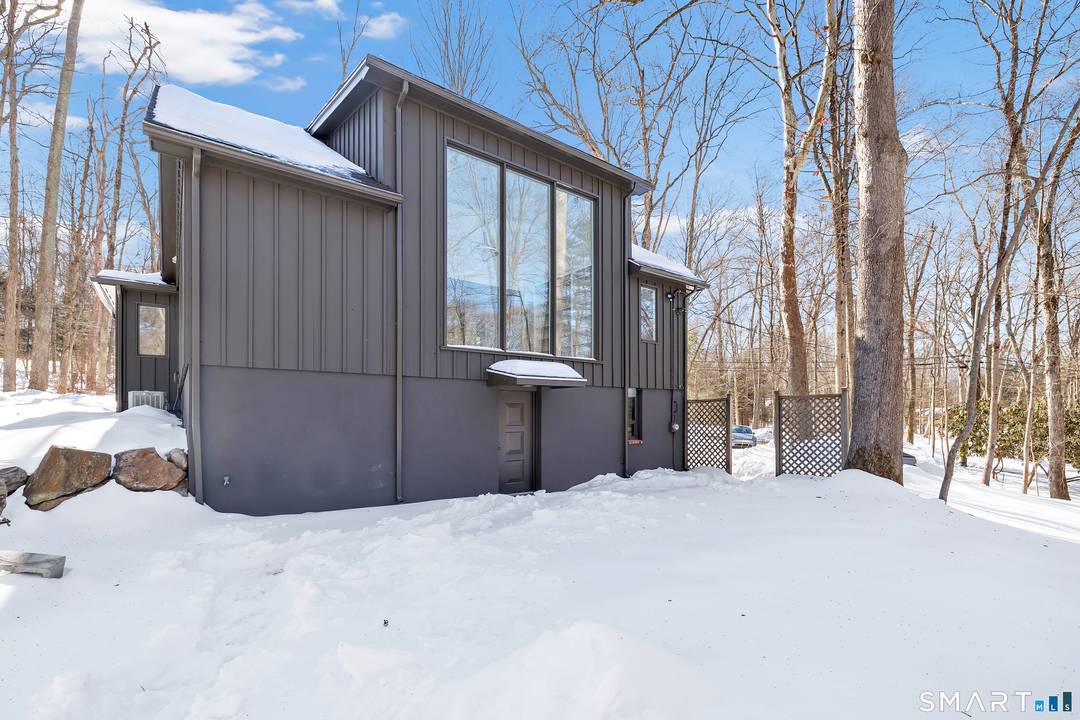 Set in Fairfield's desirable Aspetuck area, this special property feels like a private retreat, tucked away with stunning views of the Aspetuck River and waterfall in every season.