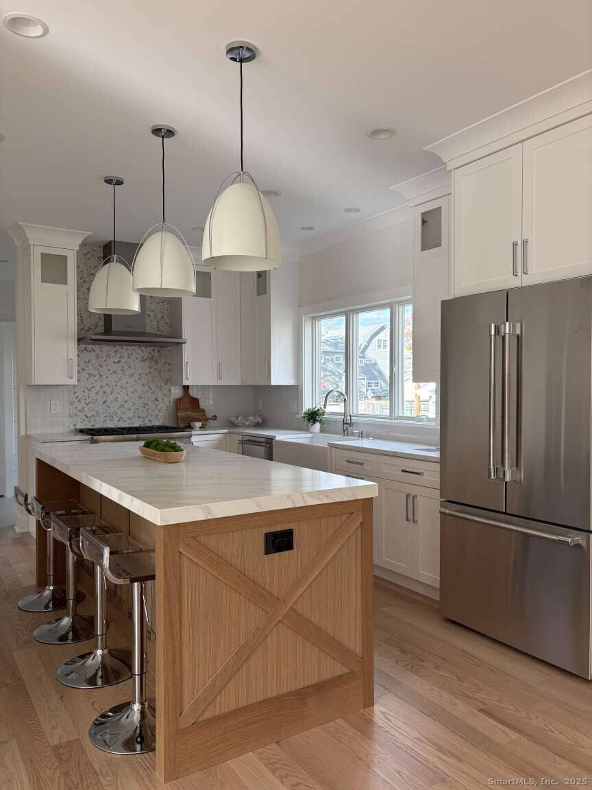 This new Construction exceptional coastal residence offers a rare blend of timeless design and modern finishes, just moments from the beach.