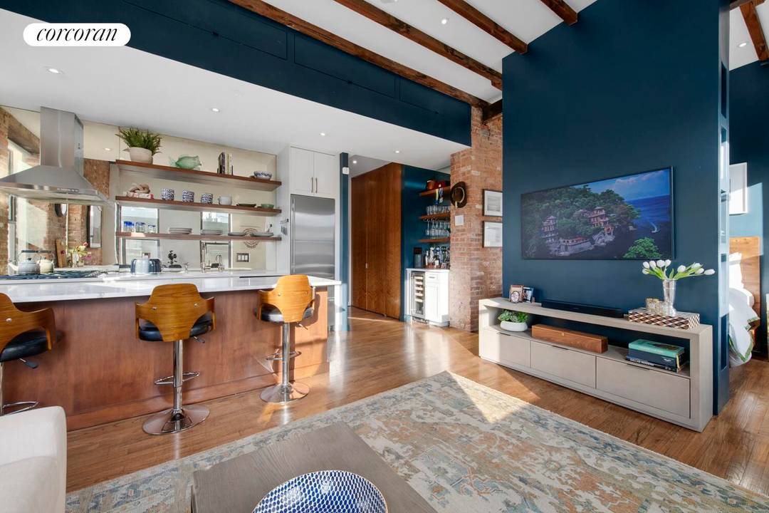 Welcome home to one of SoHo's most special offerings a sun drenched, top floor junior one bedroom carefully designed by an architect, effortlessly blending pre war charm with a stunning ...