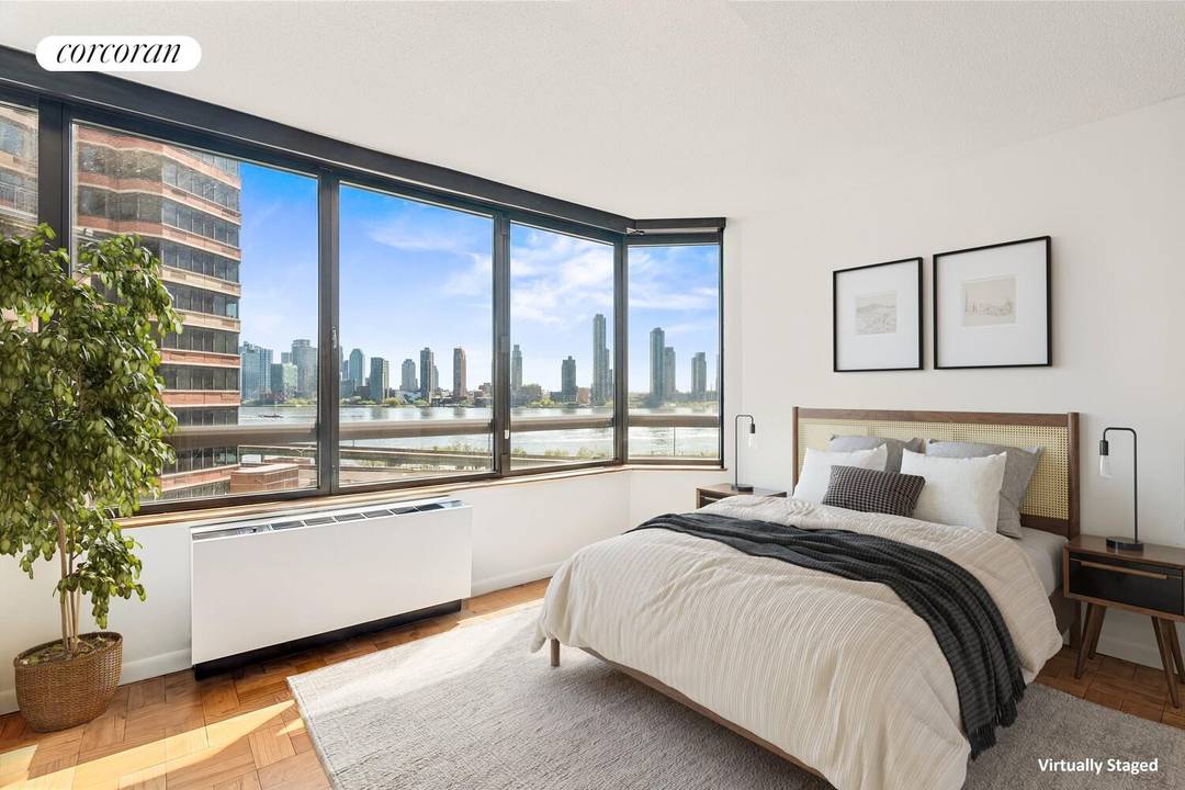 Apartment 8N at 630 First Avenue is a beautifully appointed two bedroom, two bathroom condo showcasing sweeping wraparound East River views through oversized windows.