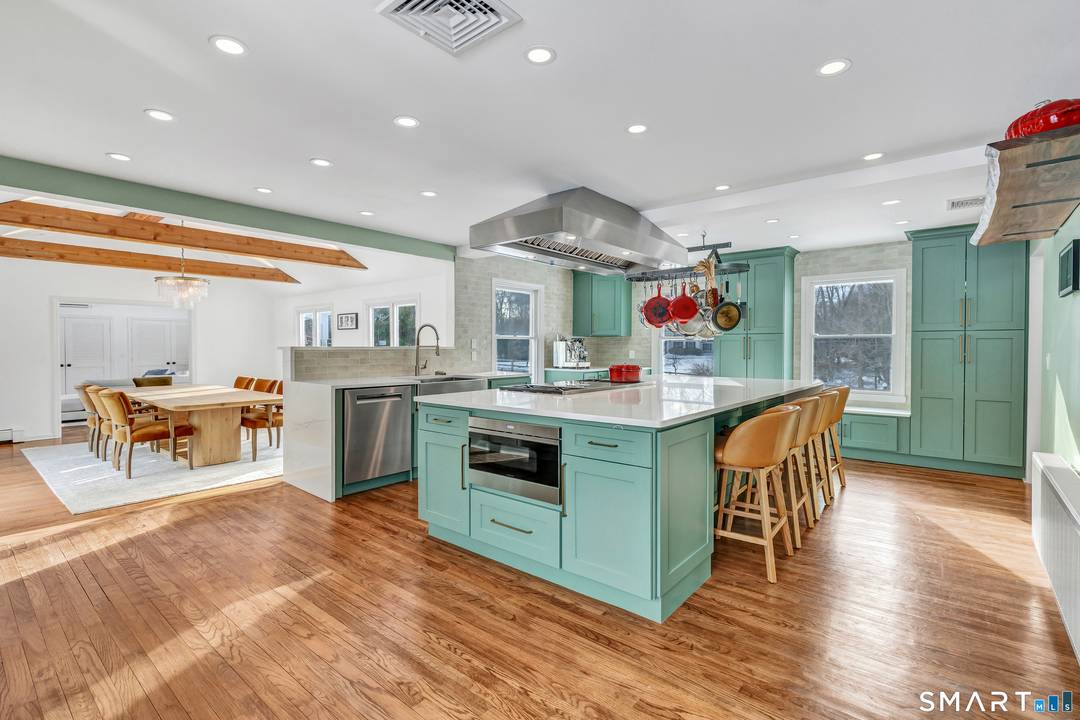 Welcome to this recently updated New England retreat with stone walls, a circular gravel driveway, and manicured grounds.