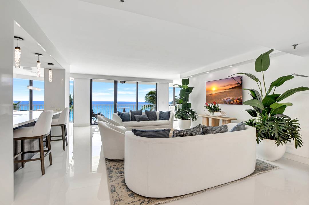 Rare, direct oceanfront views embrace this beautifully updated two bedroom, two and a half bath residence with a convertible den office sitting area.