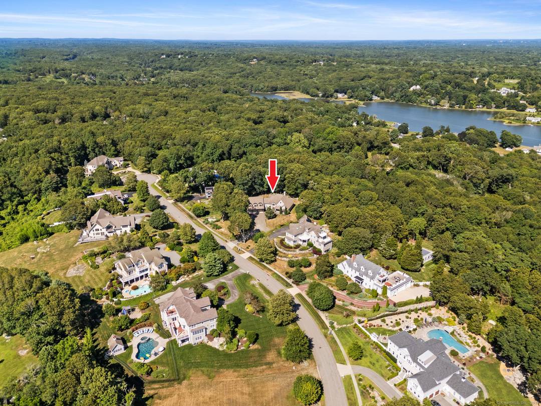 Experience upscale living in this stunning contemporary home, perfectly perched on a hillside with sweeping views across the Mystic River Valley to the waters of Fishers Island Sound.