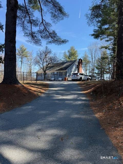 Charming Cape Cod set on a beautiful wooded lot with a fenced in yard and above ground pool, perfect for relaxing and entertaining !