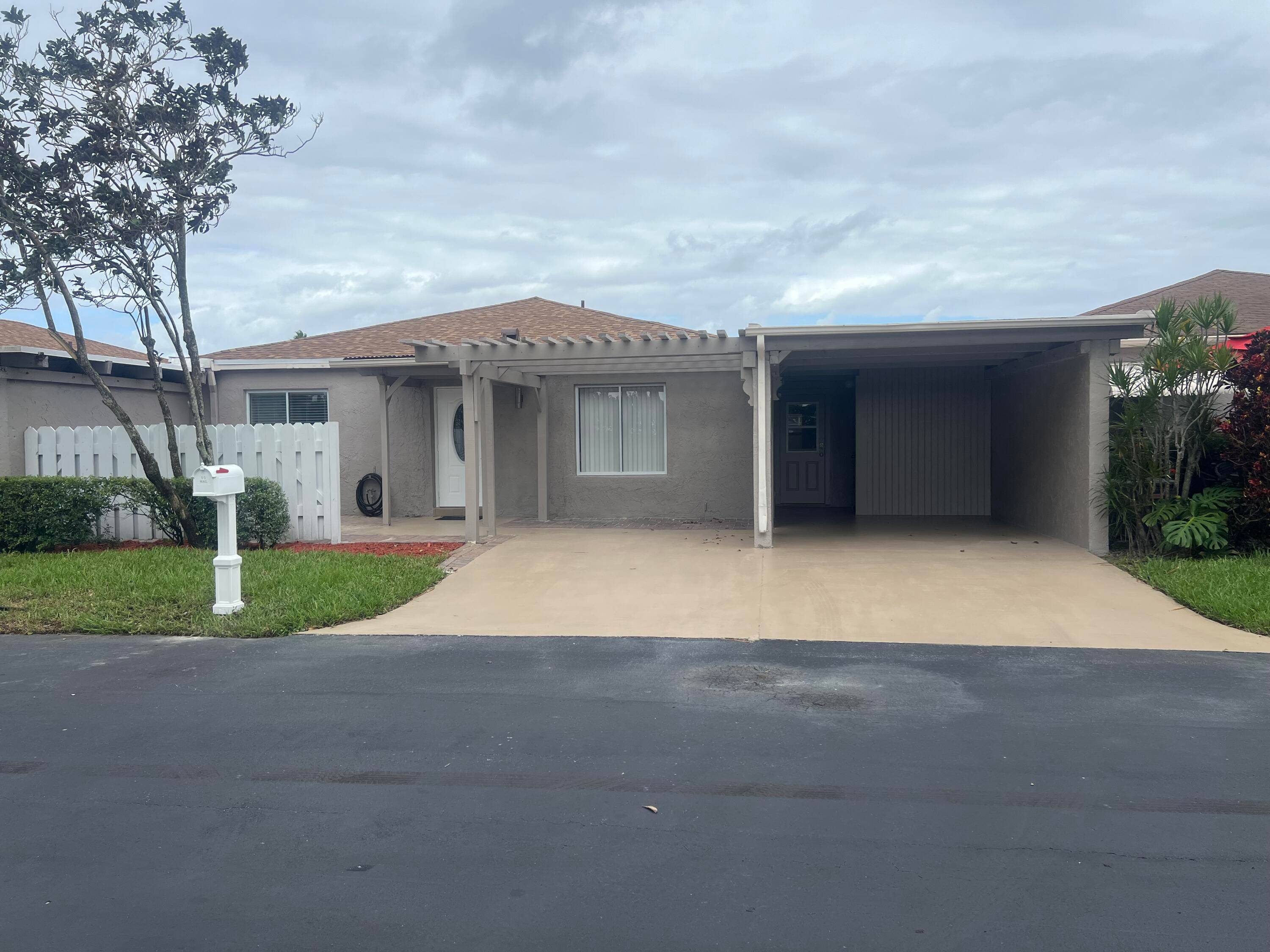 Large Renovated Villa solid concrete construction, 2 car driveway with Carport for covered parking on Private street.