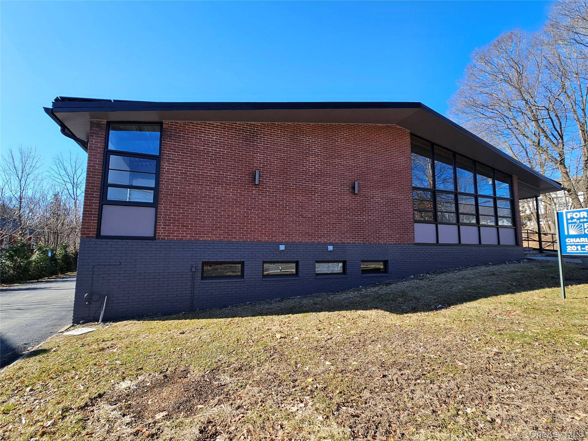 Exceptional opportunity, beautiful 1, 525 sq ft lower level Retail Office building with a rare large private parking lot !