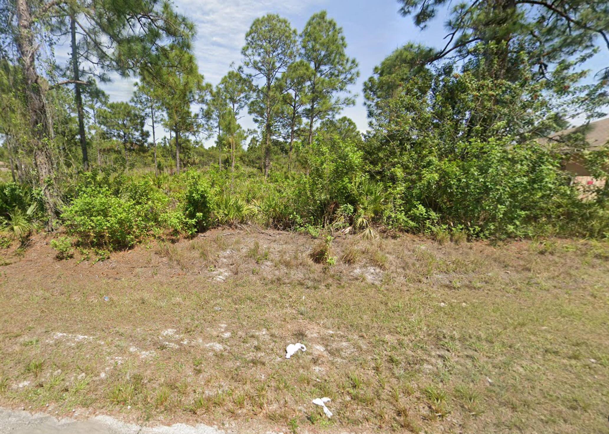 Unlock the potential of this expansive half acre parcel in the heart of Lehigh Acres.