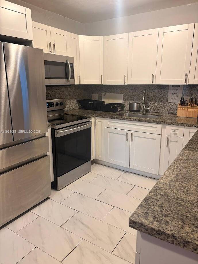 Tastefully designed 3 bedroom 3 bath home with open concept Kitchen, granite counter tops, Garage being converted to full studio, huge backyard with room for future pool, newly installed pinewood ...