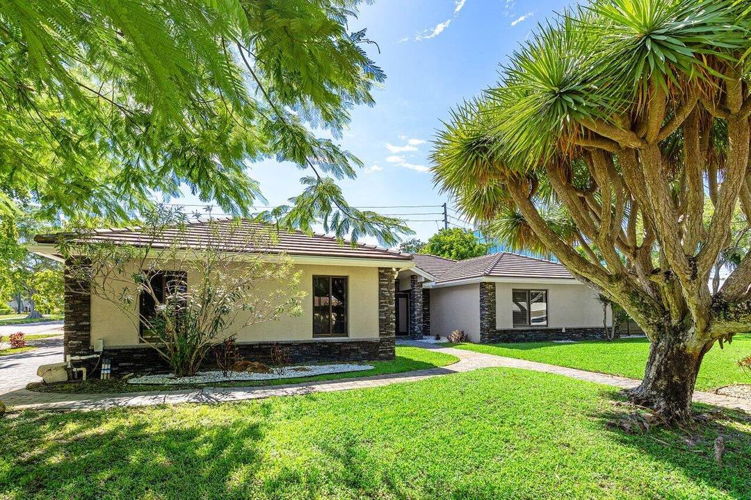 The exterior was redesigned with a refreshed facade, remodeled pool, new pavers, updated fencing, and a custom faux finish garage door.