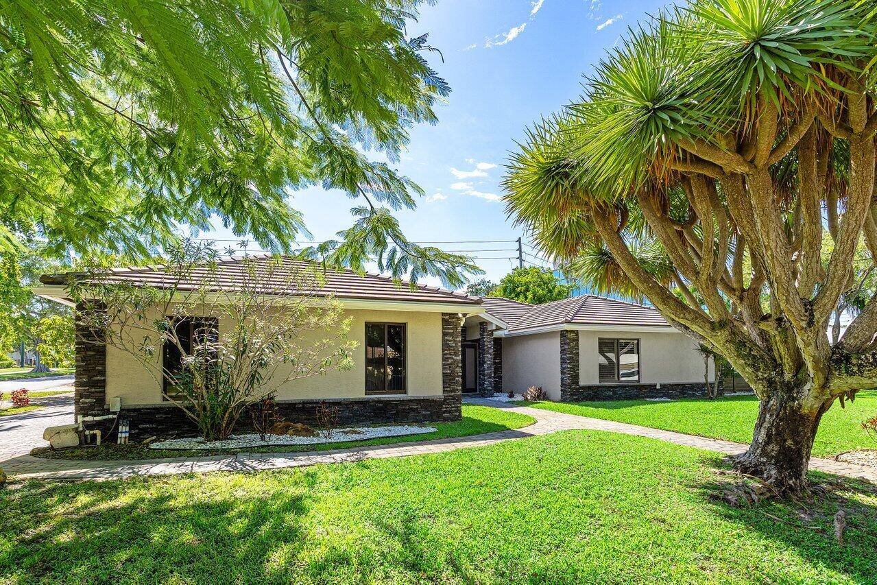 Extensively renovated home with redesigned exterior, added interior enclosure bath, pool remodel, pavers, new fence, faux finish garage door, tile floors, crown molding oversized baseboards.
