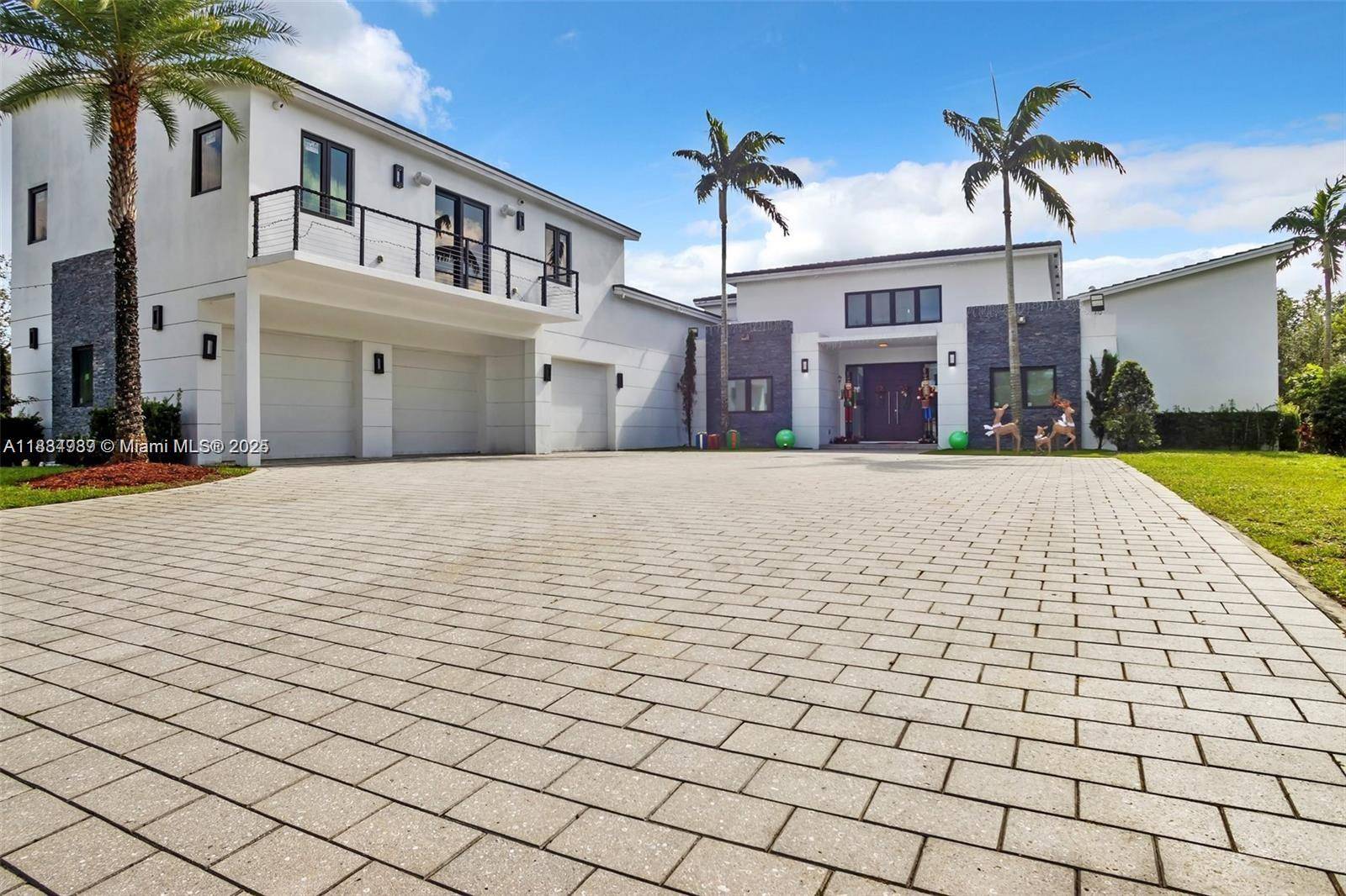 Modern masterpiece on expansive grounds, boasting soaring 20 ft ceilings, sleek porcelain floors, and a chef s kitchen with custom cabinetry and quartz counters.