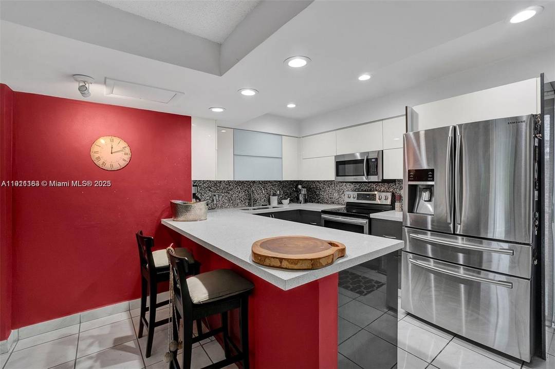 Spectacular water and Golf Course view in a tree story Townhouse Located at the Country Club of Miami 3 full bathroom 3 bedroom, SS appliances, Washer and Dryer, balcony, patio, ...