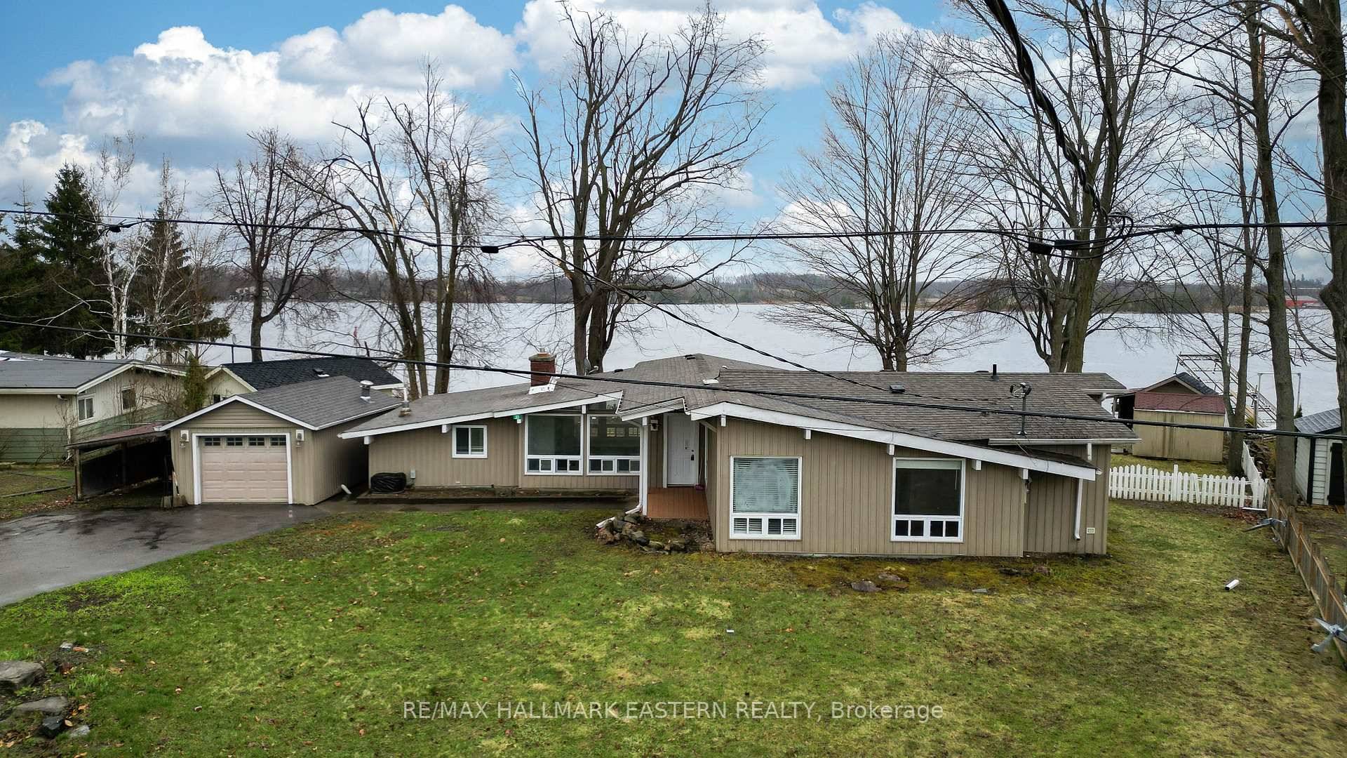 WATERFRONT GEM IN THE HEART OF IT ALL Discover the epitome of lakeside living with this waterfront gem offering 1, 926 square feet of main floor living on virtually one ...