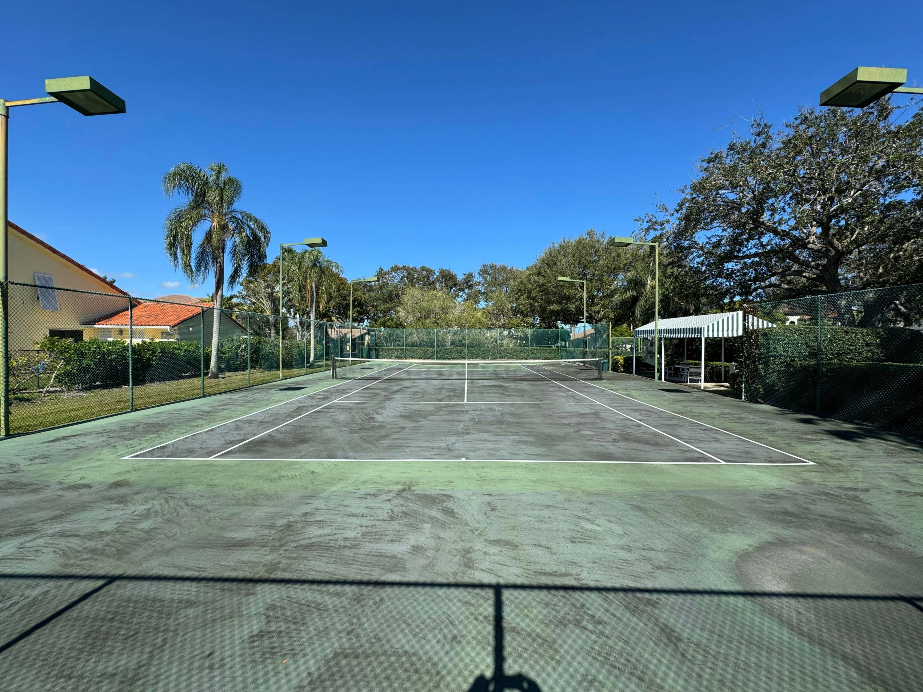 CURRENT USE OF THE LAND IS A TENNIS COURT.