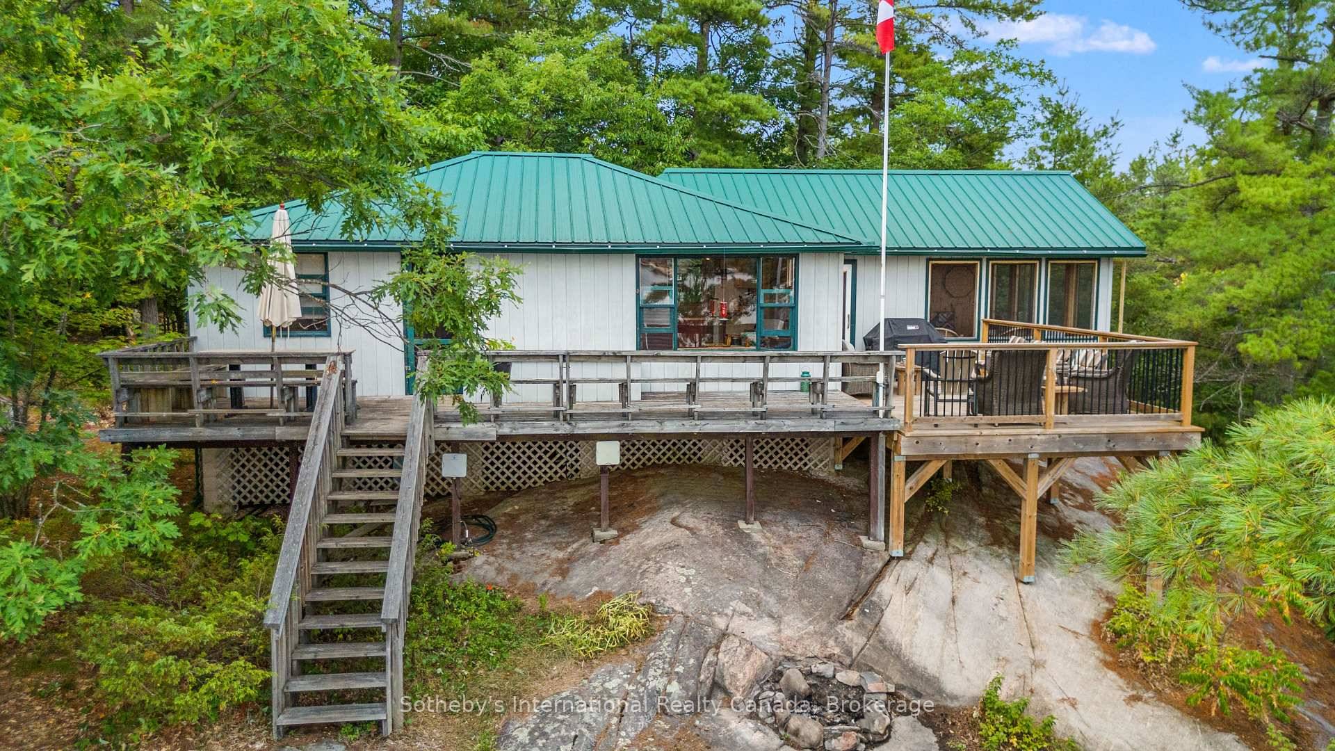 Set on a private 1. 49 acre landscape of granite outcrops and windswept pines, this classic Muskoka escape commands sweeping views over Paradise Bay on Go Home Lake.