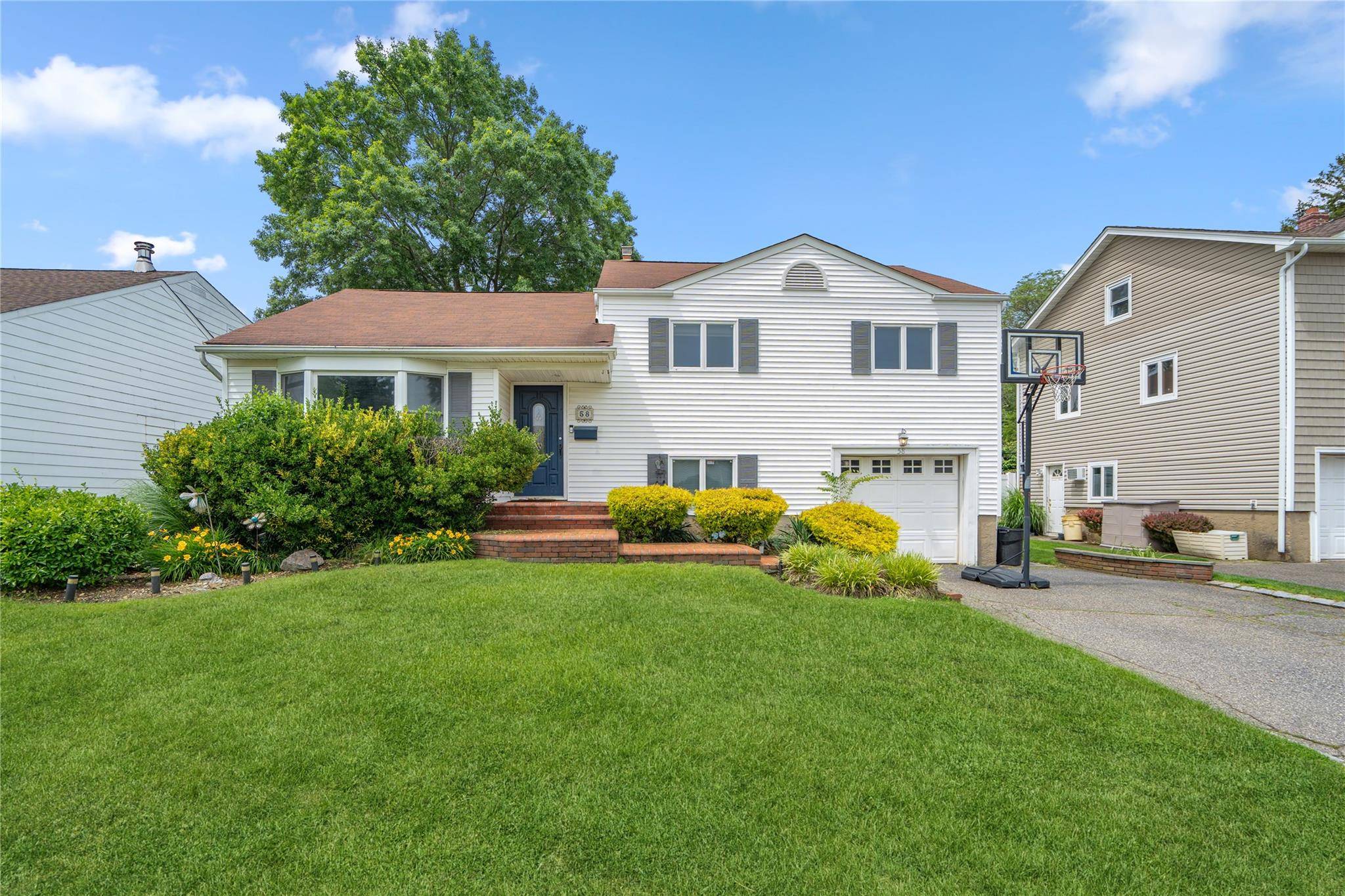 SYOSSET. Do not miss out on this incredible south facing expanded 3 bedroom, 2 bathroom home in the heart of Syosset.