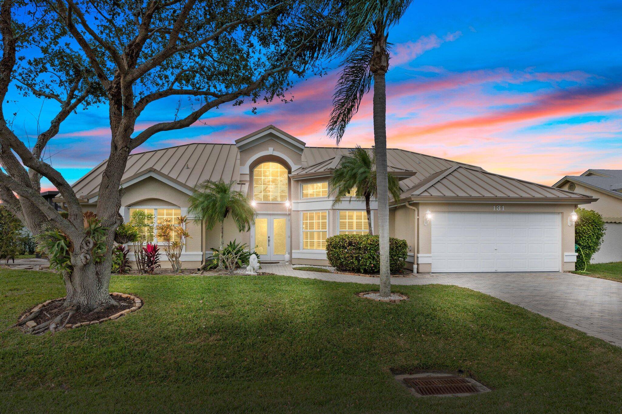 Island living at its finest in sought after Queens Cove !