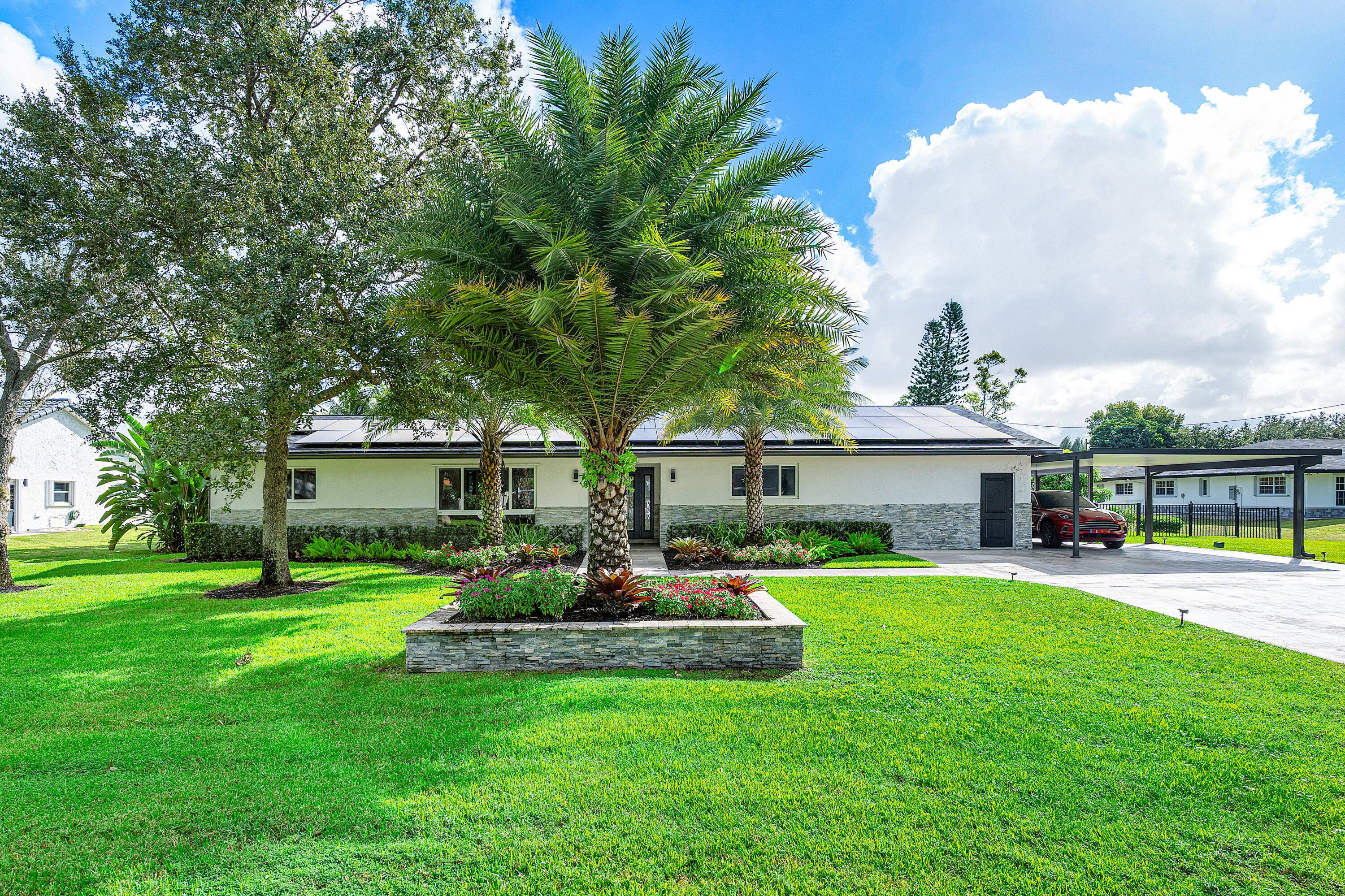 Welcome to 5050 SW 168th Ave a meticulously rebuilt oasis on a full acre in Southwest Ranches.