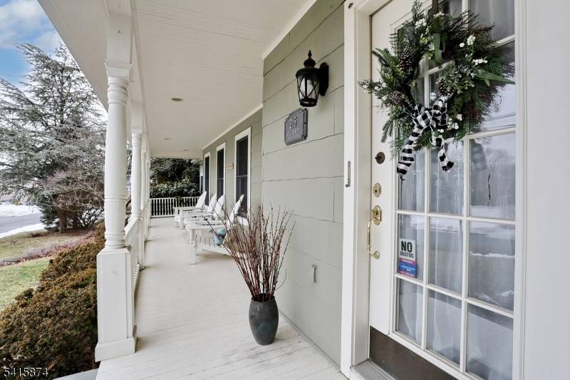 A charming lemonade porch sets the tone for this warm and inviting home.
