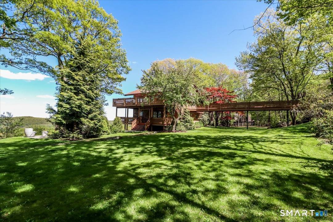 Perched high above Lake Mamanasco at one of Ridgefield's most breathtaking vantage points, this extraordinary modern residence captures spectacular year round lake and distant mountain views from nearly every room.