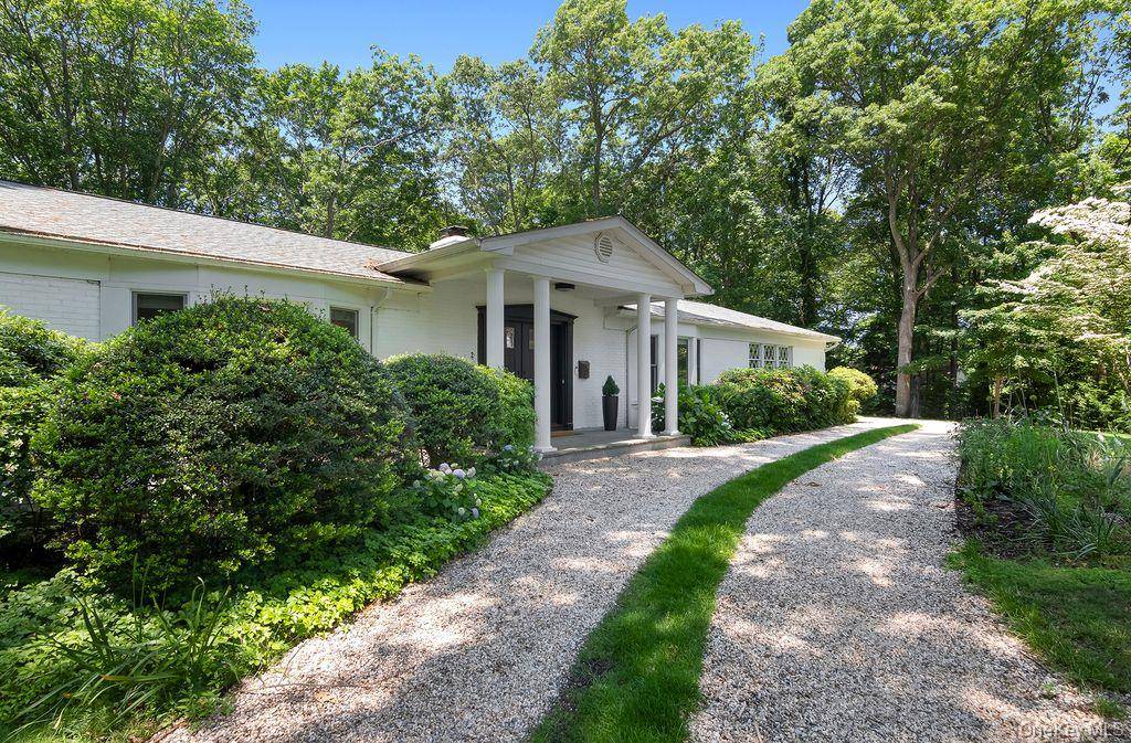 Completely renovated 1964 four bedroom Ranch with central heat gas and AC in Belle Terre on 1 acre.