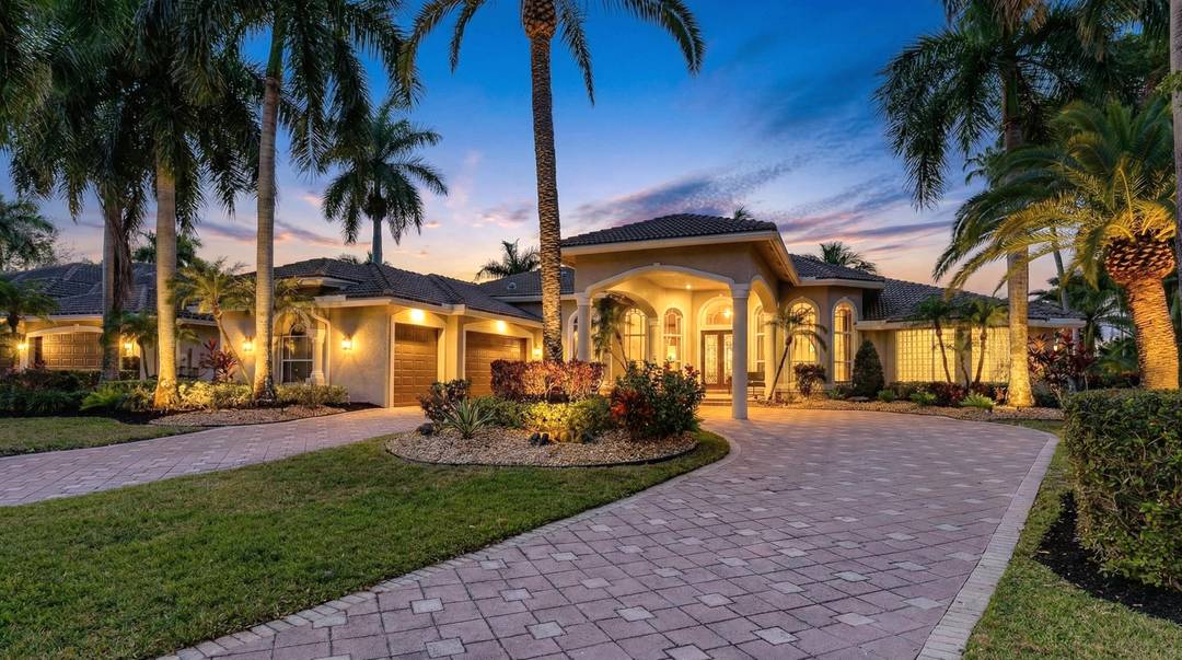 Discover unparalleled South Florida sophistication in this exquisite one story custom residence nestled within the exclusive, double gated enclave of 'The Falls' in the coveted Heron Bay community.