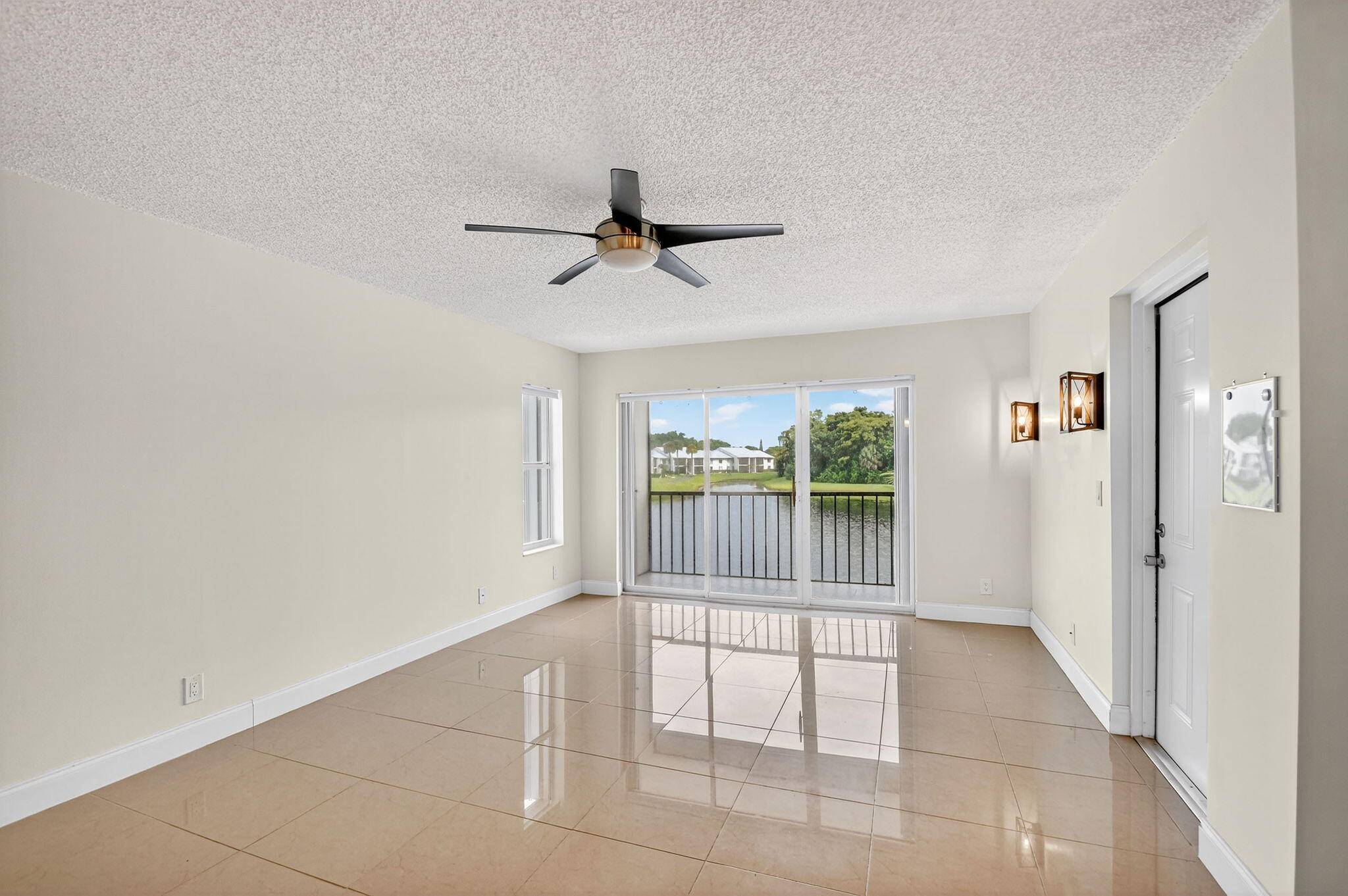 Welcome to this beautifully updated 2 bed, 2 bath condo in the gated community of Palm Club Village, where serene lake views greet you from every window.