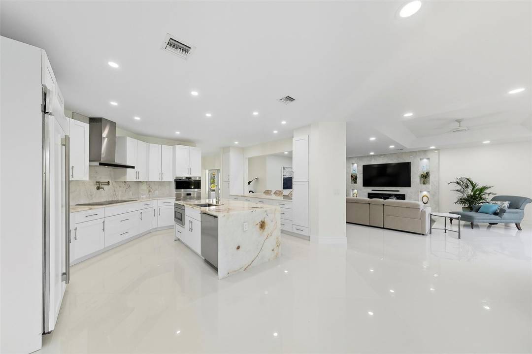 Welcome to this beautiful, completely remodeled home in the prestigious gated community of Maplewood Isles.