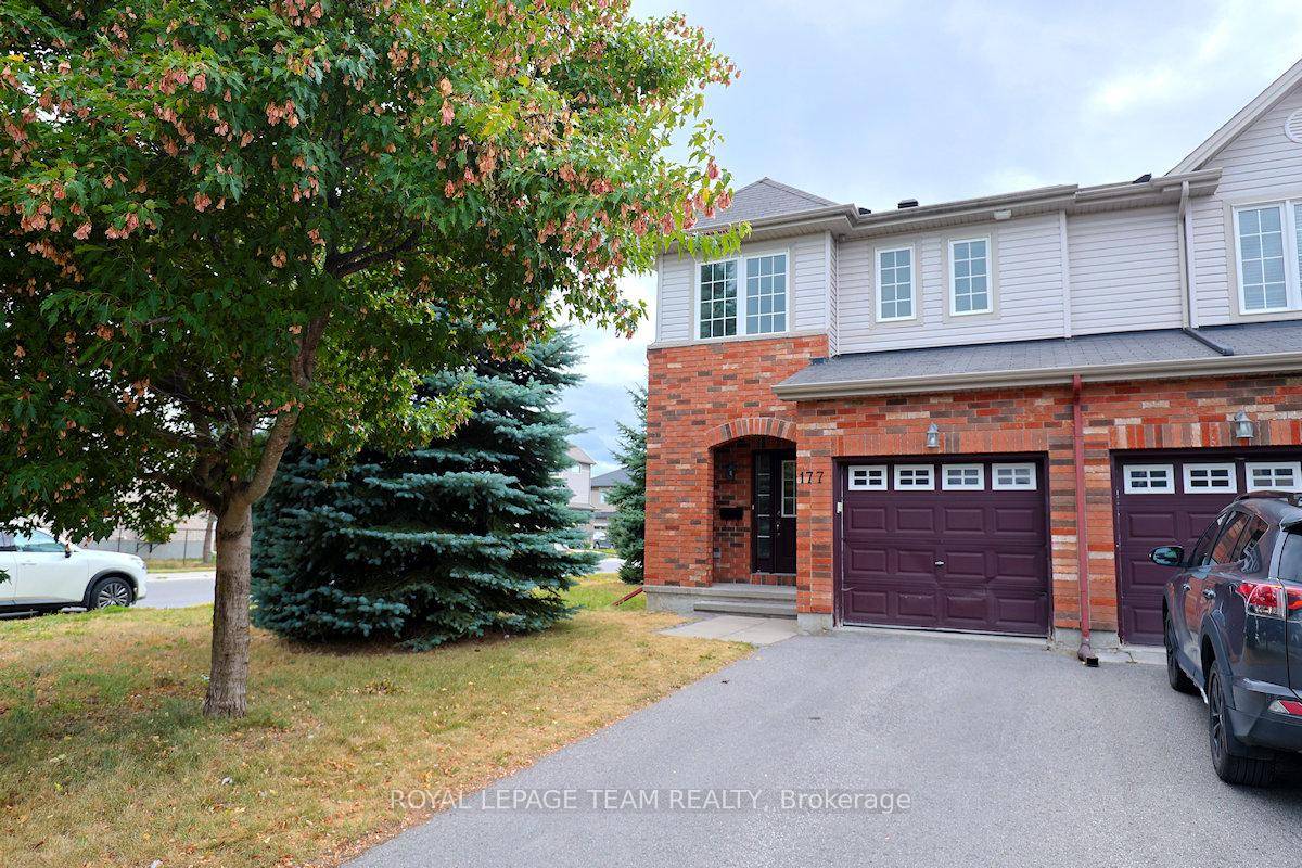 Great three bedroom end unit townhome on a corner lot in Bridlewood Trails.
