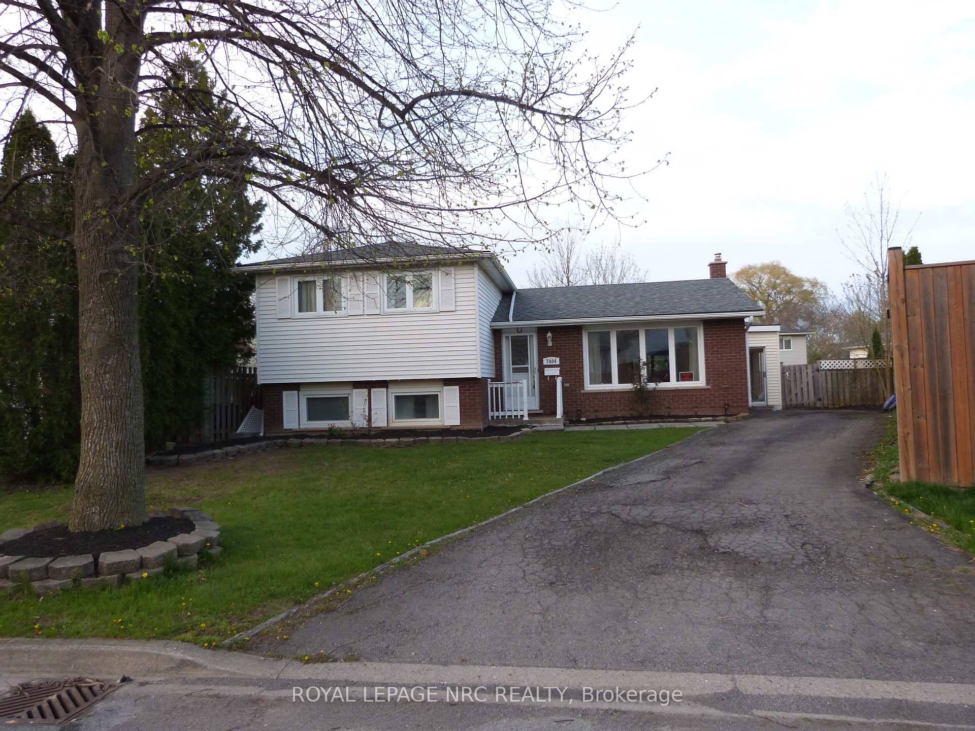 This 4 level side split house features a kidney shaped in ground pool and a large sunroom over looking the landscaped yard and pool.