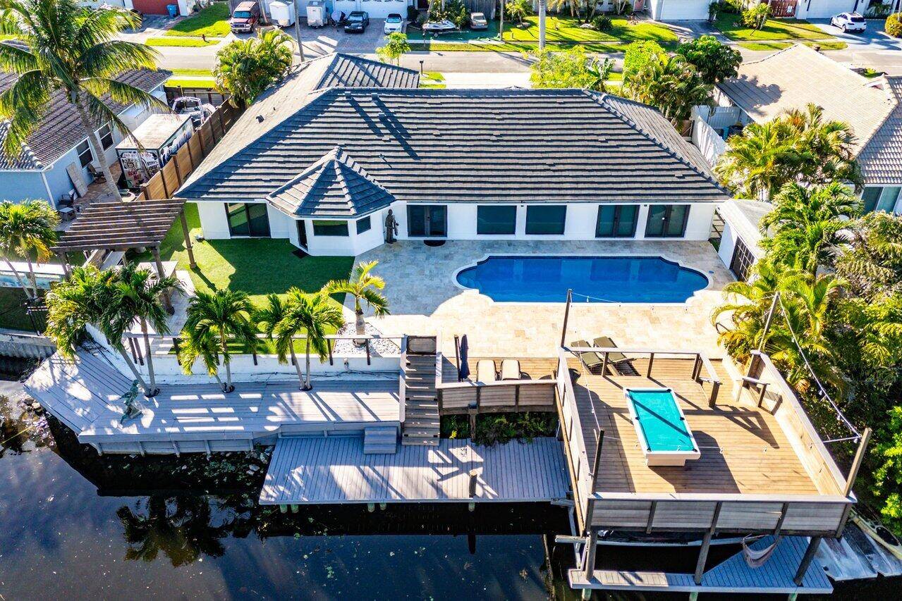 Discover this beautifully remodeled contemporary waterfront home, perfectly situated on the E7 canal off Lake Ida.